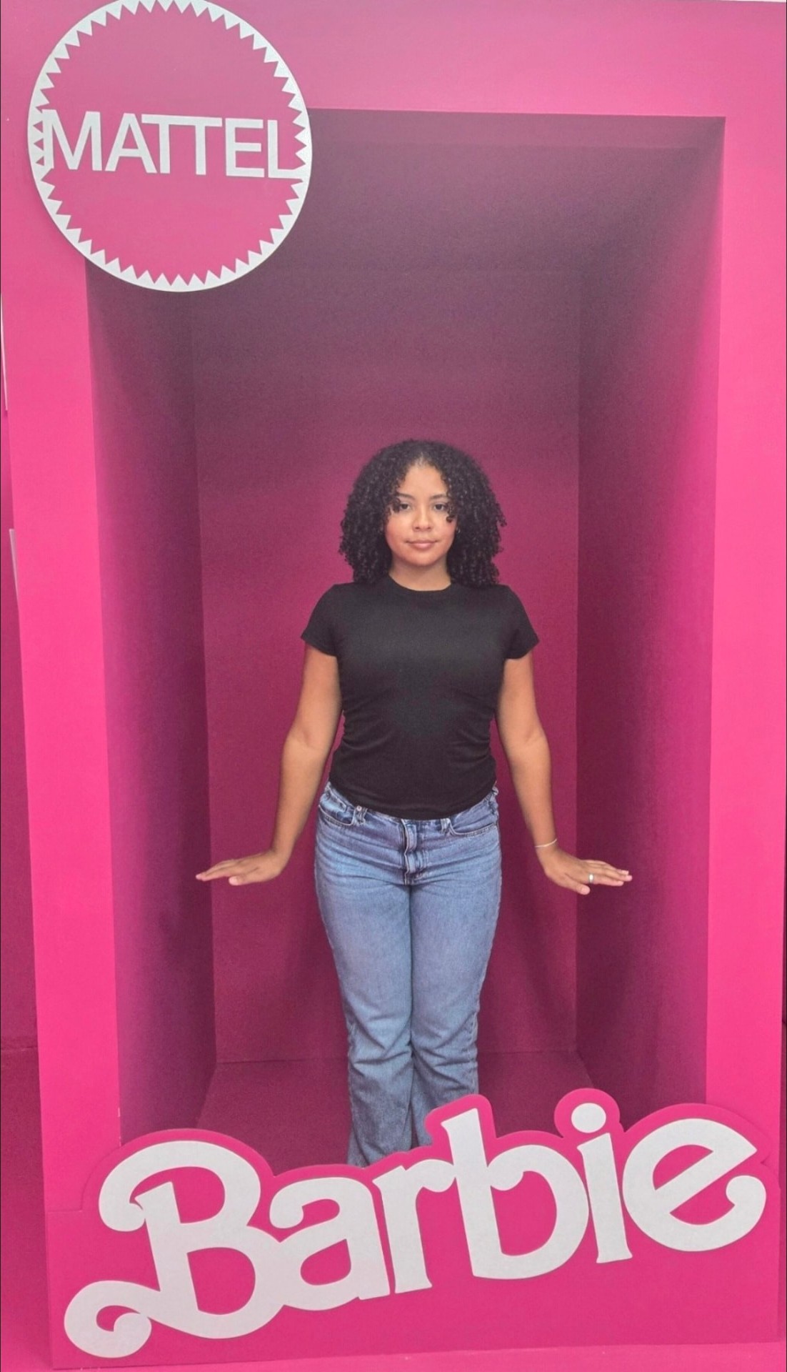 Guest posing inside the life-size pink Barbie box at The Williamsburg Selfie Museum